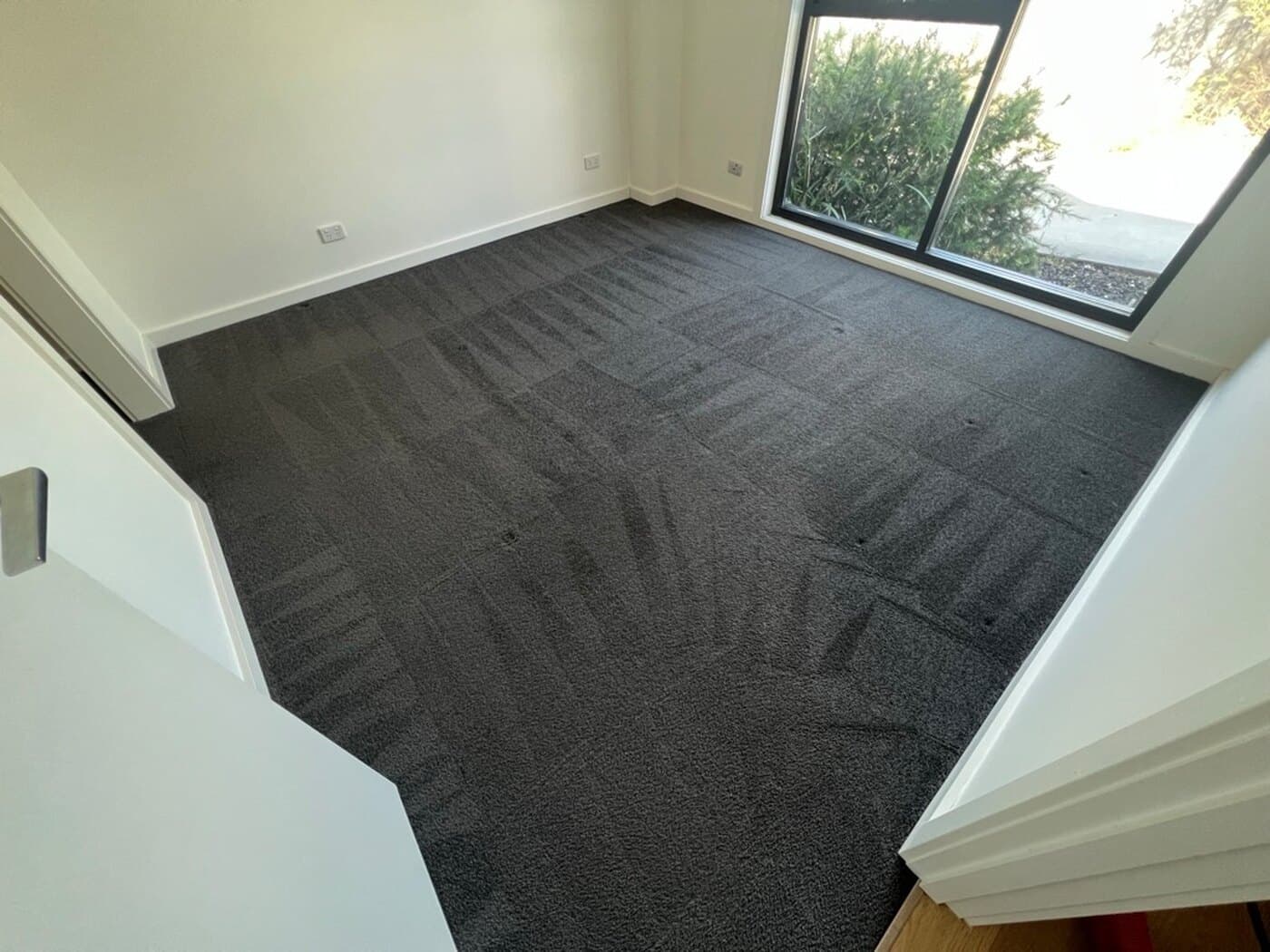 Dark grey carpet before and after a carpet clean