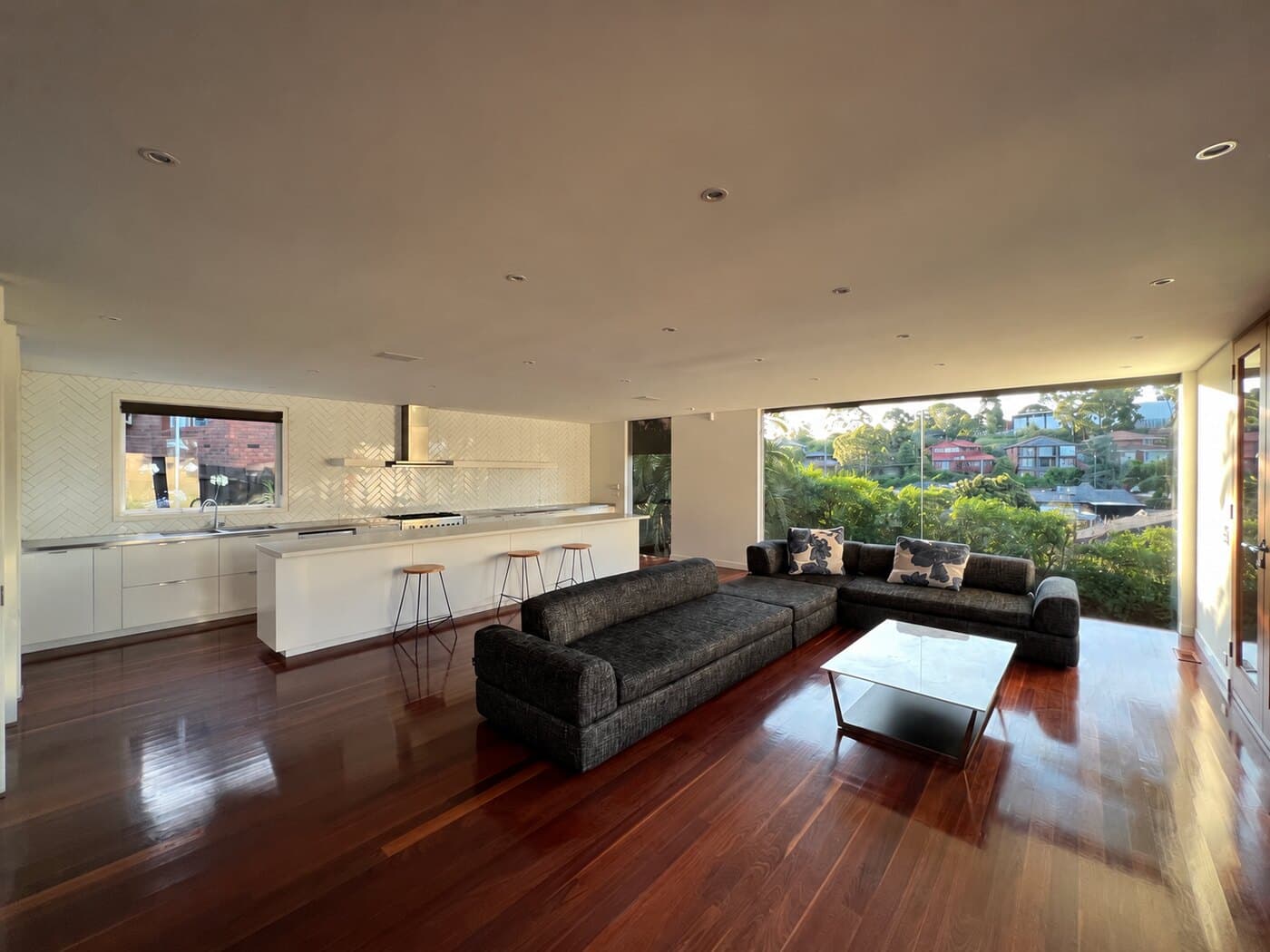 Open-plan living room and kitchen before and after a pre-sale clean
